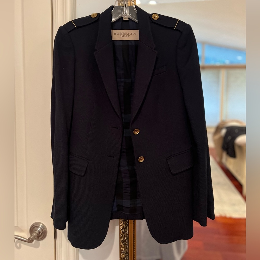 Burberry coat in navy blue, 100% cotton. Gold button & zipper detail. Unworn
